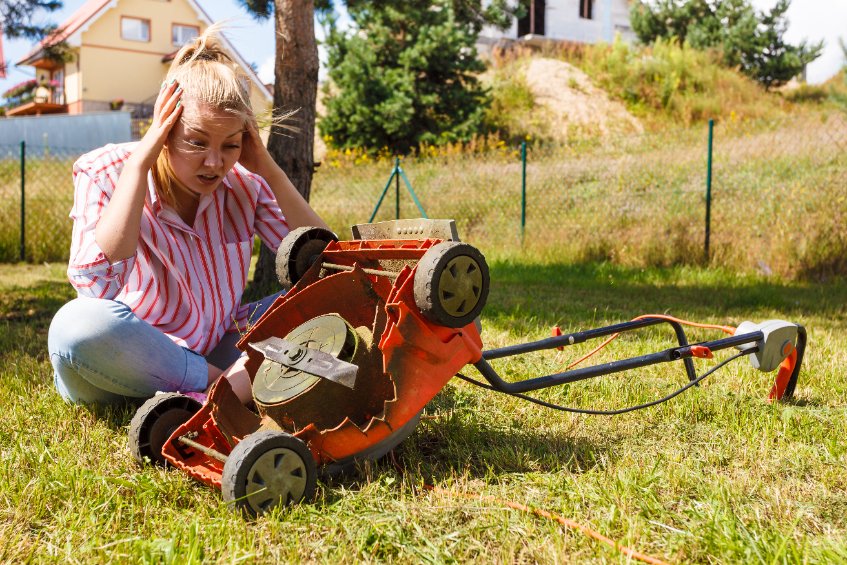 Woman fretting over broken mower